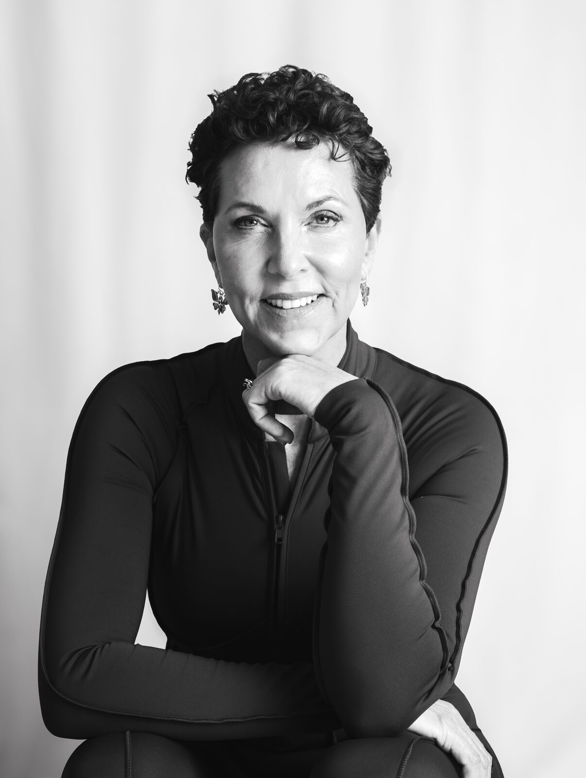 Black and white portrait of Grace Walcott, seated with arms crossed