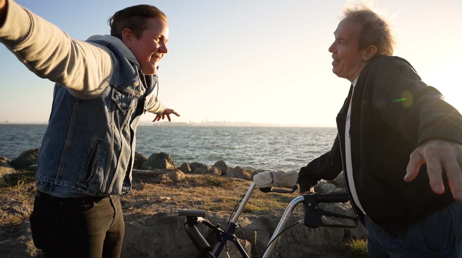 Two elders face each other in animated conversation outdoors